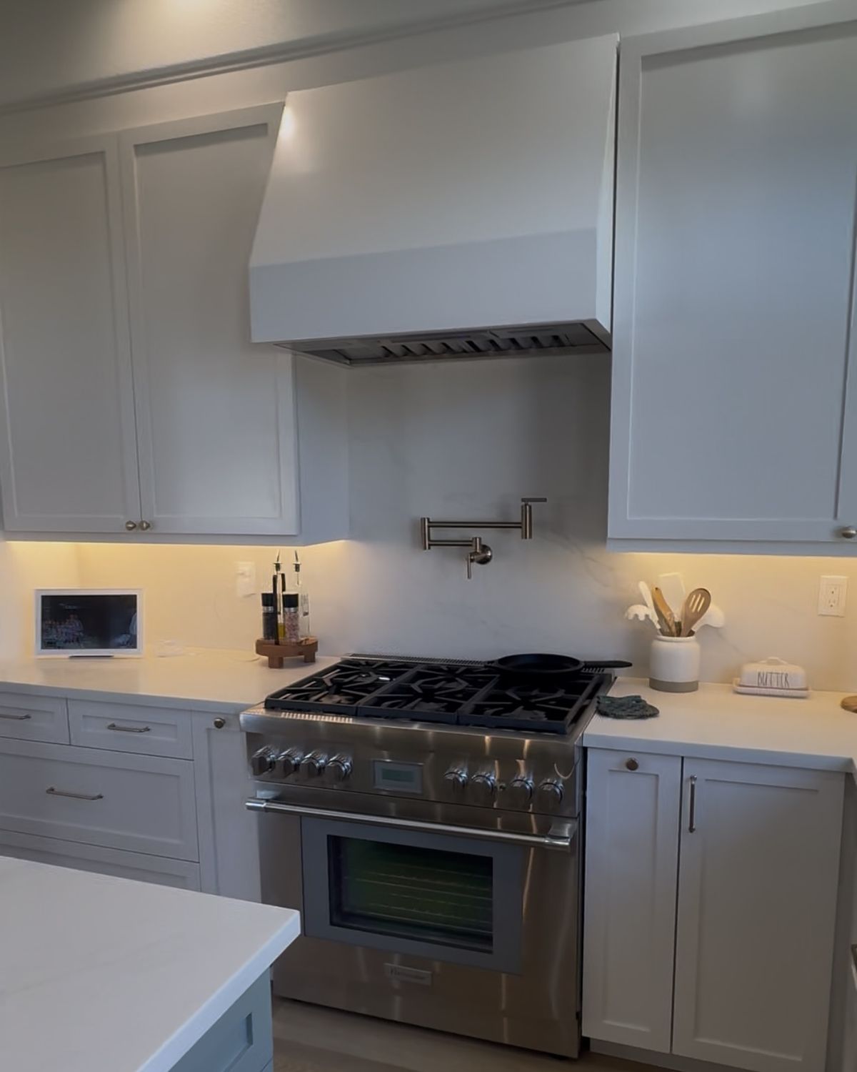 After: new kitchen with white range hood